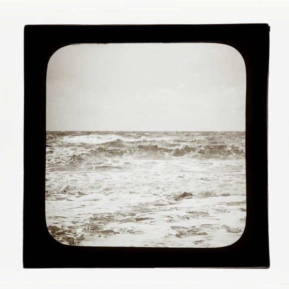 A magic lantern slide of sea waves crashing against the shore by Birt Acres, c. 1893.